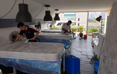 two experts cleaning mattress