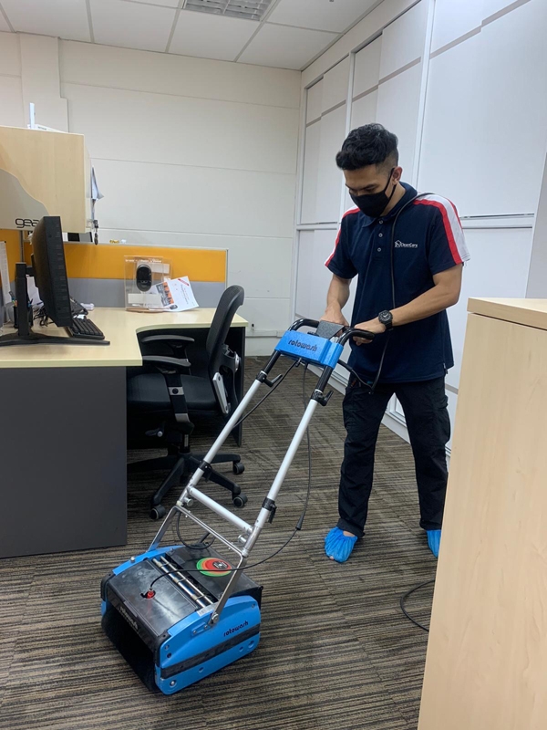 A Man Cleaning a Carpet