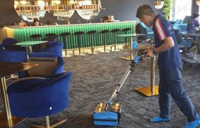 A person cleaning in the lobby-professional carpet cleaning singapore