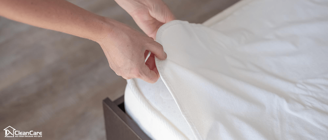 cleaning service inserting mattress protector