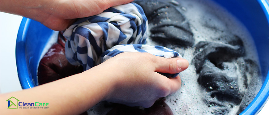 Image of a stained piece of clothing being scrubbed