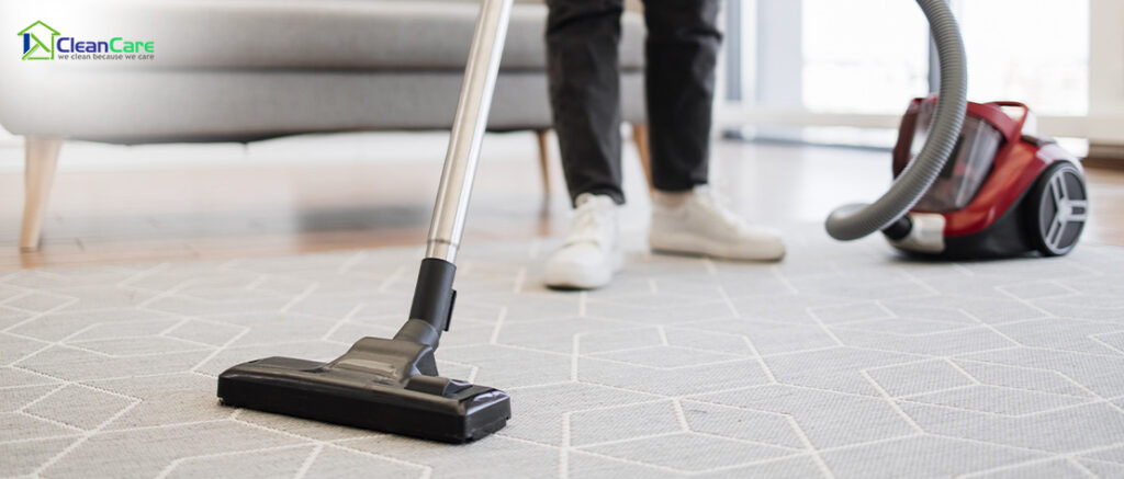 Vacuum cleaner being used on a rug.